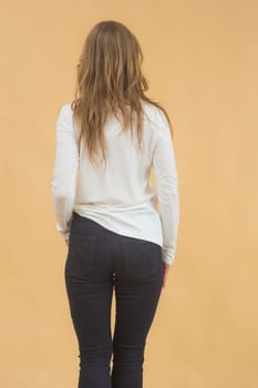 A woman in clothes on the background in the studio, fitting clothes.