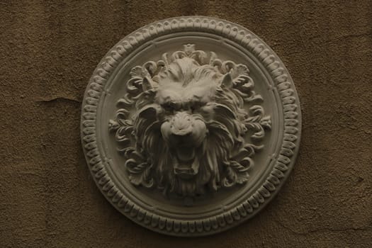 plaster bas-relief Greek characters a lion on a white background.