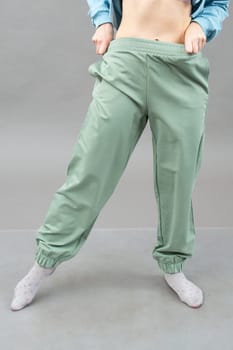 A woman in clothes on the background in the studio, fitting clothes.