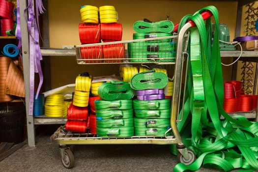 Industrial sewing machine sews a webbing sling. Manufacture of textile slings and tie straps