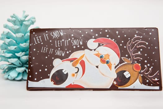 Milk and dark chocolate with a Christmas theme .