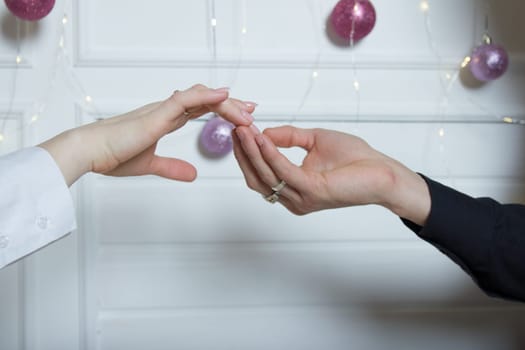 Couples holding hands.a man's hand touches a woman's hand.