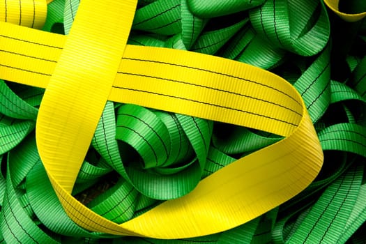Industrial sewing machine sews a webbing sling. Manufacture of textile slings and tie straps