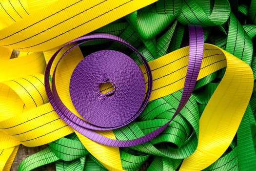 Industrial sewing machine sews a webbing sling. Manufacture of textile slings and tie straps