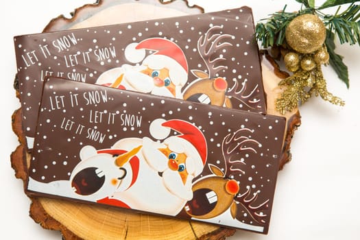 Milk and dark chocolate with a Christmas theme .