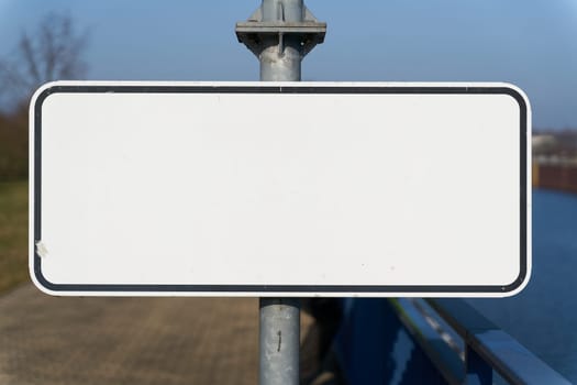 blank white sign with text space on a pillar
