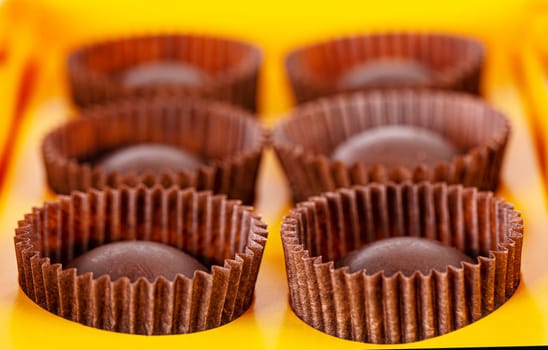 The box with tasty delicious round chocolate candys. Selective focus