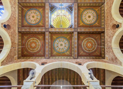 Wooden ceiling decorated with colorful floral patterns and dome at Mamluk era Imam Al Sfafii Mosque situated Old Cairo, Egypt