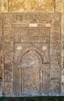 Ornate engraved stone wall with floral patterns and calligraphy at Tulunid era Ibn Tulun Mosque, Cairo, Egypt