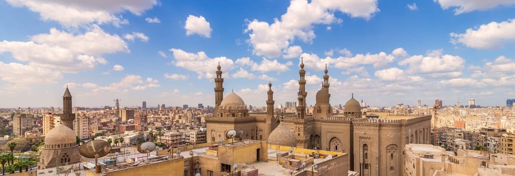 A panoramic shot of minarets and domes of Sultan Hasan Mosque and Al Rifai Mosque in Cairo, Egypt