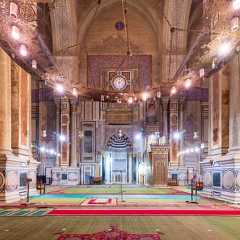 Interior of public historical Al Rifaii Mosque, aka Royal Mosque, with colorful decorated engraved Mihrab and wooden Minbar, Cairo, Egypt