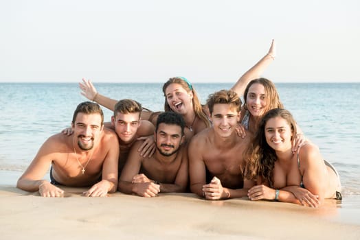 Group of happy young people at the beach