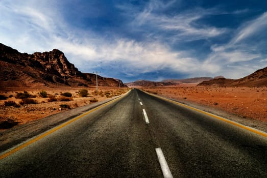 Road in jordanian desert with dramatic sky