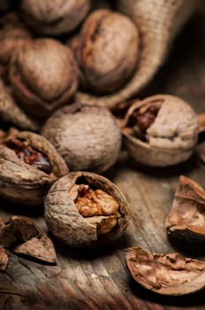 Cracked walnuts on rustic wooden table