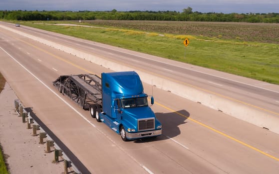 A big Rig car hauler rolls down the highway headed to pick up the next cargo