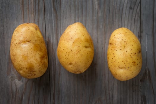 Fresh Potato on Wooden Table Background, Concept and Idea of Food Cook Rustic Still life Style. Dramatic light table setting.