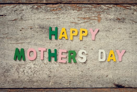 The words "HAPPY MOTHERS DAY"" on old wooden plank."