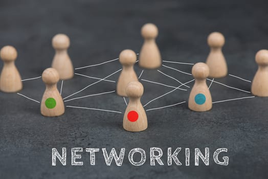 Wood figures, group of people connecting through a web, business networking and communication concept, leadership