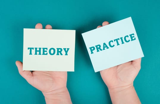The words theory and practice are standing on pieces of paper, education concept, learning by doing