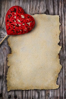 Valentine heart and old empty page on wooden background