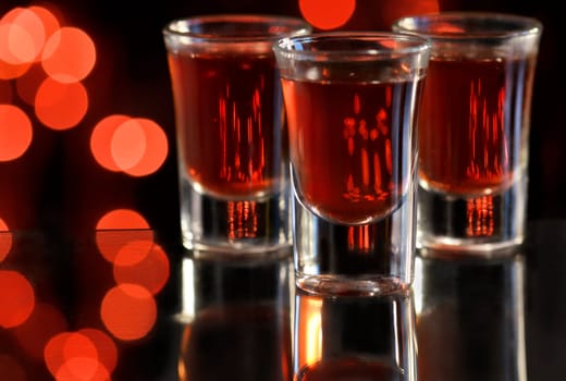 Red cocktail in shot glasses