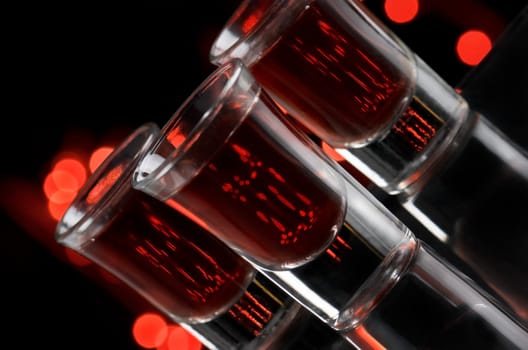 Red cocktail in shot glasses