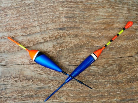 big blue fishing floats crossed lie on wooden background close-up still life
