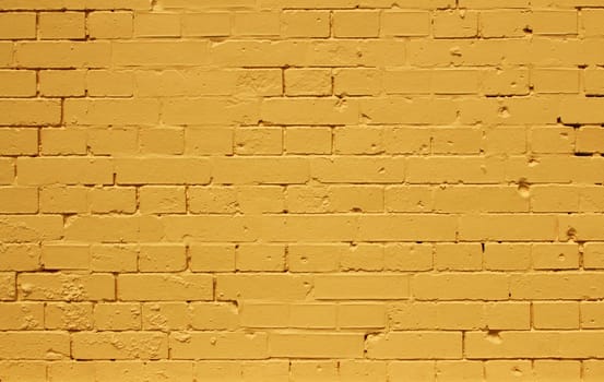 Background pattern texture made from a bright yellow brick wall