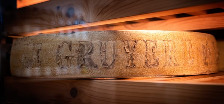 December 3 2021, Lyon, Rhone Alpes Auvergne, France : Swiss PDO gruyère wheel in a ripening cellar