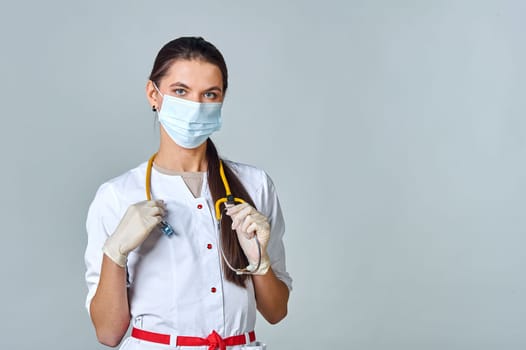 a doctor in a medical mask and a white coat with a stethoscope. High quality photo