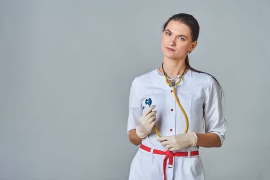 a young doctor in a white coat with a stethoscope around his neck. High quality photo