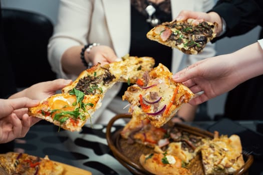 Team people eating pizza in office