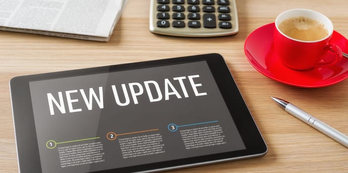 A tablet on a desk with the headline New update