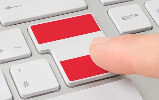 A keyboard with a labeled button - Flag of Austria