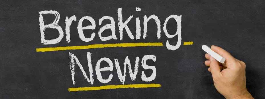 Text written on a blackboard - Breaking news
