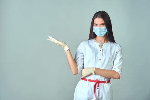 a female doctor in a medical gown warns about something important. High quality photo