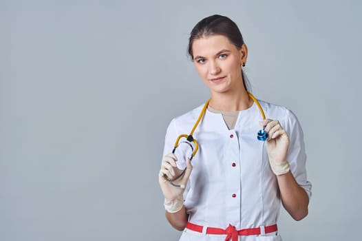 a young doctor in a white lab coat with a yellow stethoscope slung over his neck. High quality photo