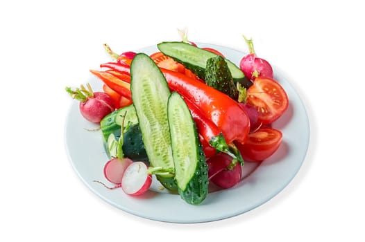 slicing fresh vegetables on a plate on a white background. High quality photo