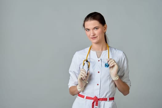 a young doctor in a white lab coat with a yellow stethoscope slung over his neck. High quality photo
