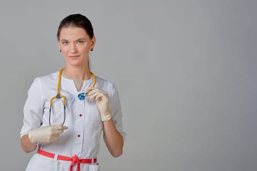 a young doctor in a white coat with a stethoscope around his neck. High quality photo