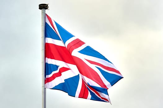 the flag of Great Britain is flying on the flagpole. High quality photo