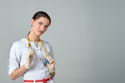 a young doctor in a white coat with a stethoscope. High quality photo