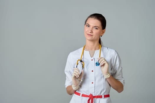 a young doctor in a white lab coat with a yellow stethoscope slung over his neck. High quality photo