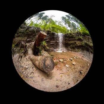 Waterfall in a forest landscape with fish-eye lens