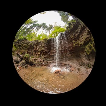 Cascade waterfall over a rock scene with fish-eye lens