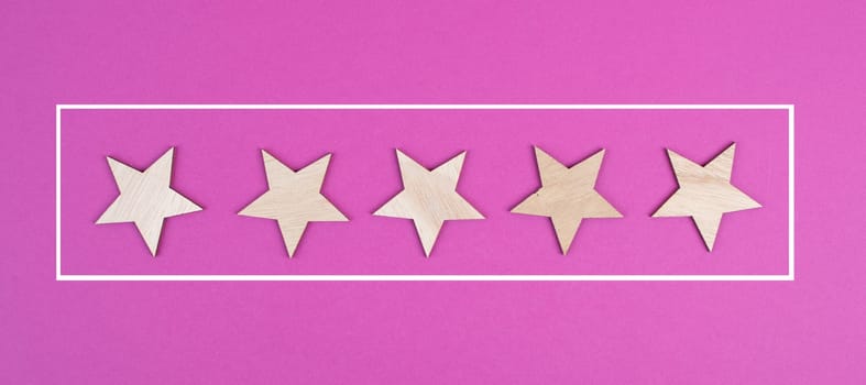 Five stars on a colored background, hand put the last star in the row, rating, giving feedback