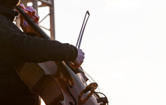 The street musician cello plays music outdoors
