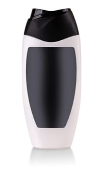 The white plastic bottle with shampoo and black label isolated on white background