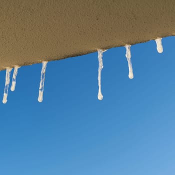 Icicles when looking out of the window of a house in winter