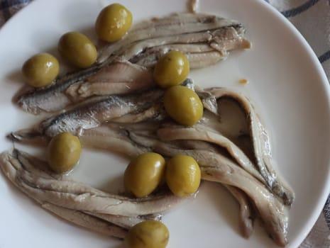 delicious appetizer of anchovies in vinegar with olives and wine